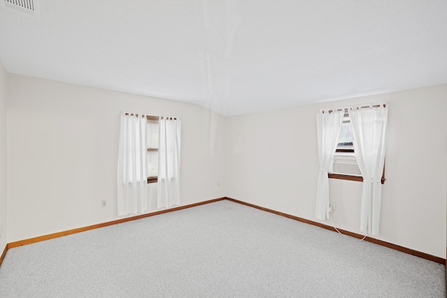 unfurnished room with vaulted ceiling and carpet flooring