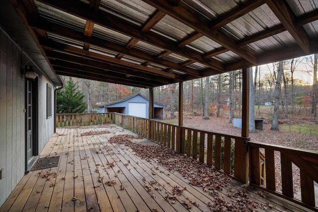 wooden deck with a garage and an outdoor structure