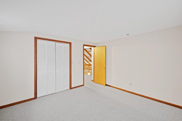 unfurnished bedroom featuring carpet floors and a closet