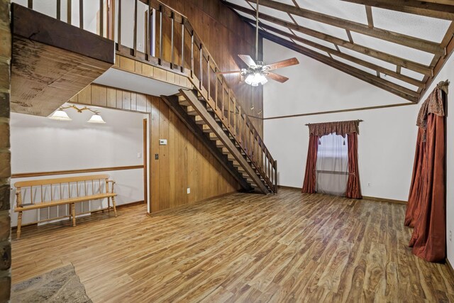 living room featuring ceiling fan, wood-type flooring, beam ceiling, and high vaulted ceiling