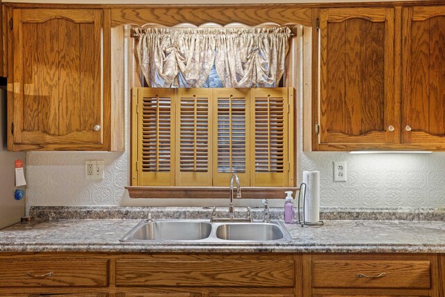 kitchen featuring tasteful backsplash and sink