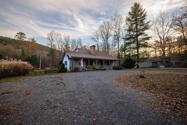 ranch-style house with a mountain view and a porch