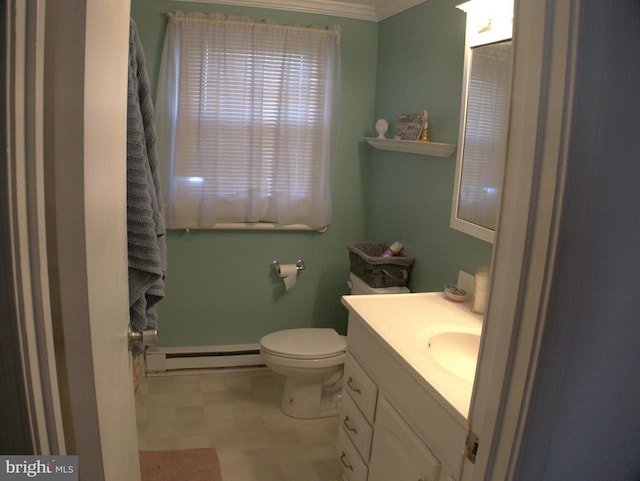 bathroom featuring toilet, a baseboard heating unit, ornamental molding, vanity, and tile patterned floors