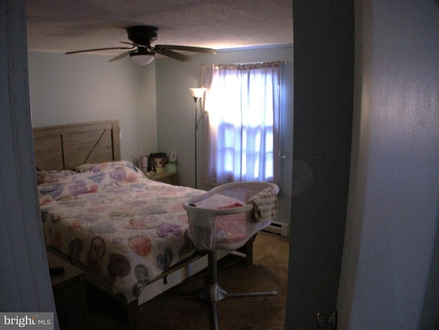 bedroom featuring baseboard heating and a ceiling fan