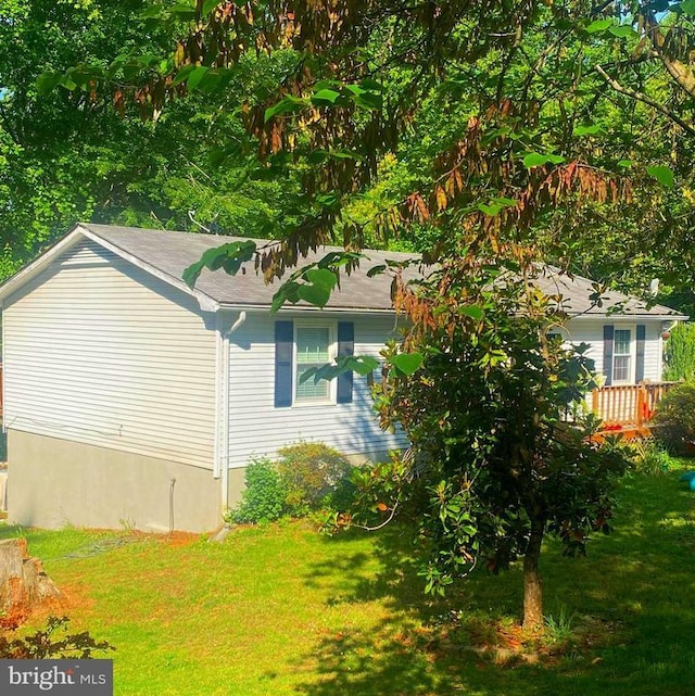 view of side of home featuring a lawn