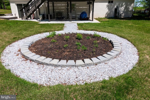 view of yard featuring a patio area and stairway