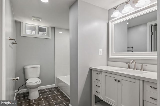 bathroom featuring visible vents, vanity, baseboards, tile patterned floors, and toilet