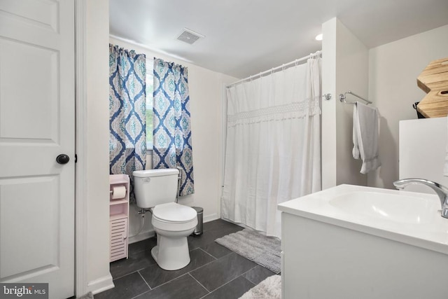 full bathroom with toilet, vanity, visible vents, and tile patterned floors