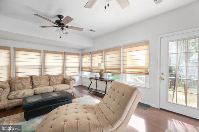 sunroom / solarium with visible vents and a ceiling fan