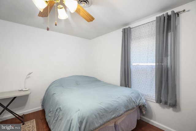 bedroom featuring ceiling fan, wood finished floors, and baseboards