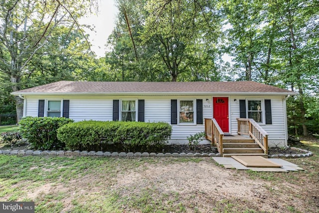 single story home featuring roof with shingles