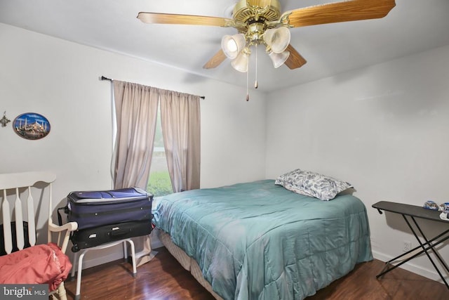 bedroom featuring ceiling fan, baseboards, and wood finished floors