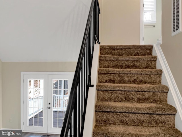 stairs featuring french doors