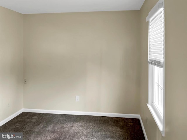 empty room with dark carpet