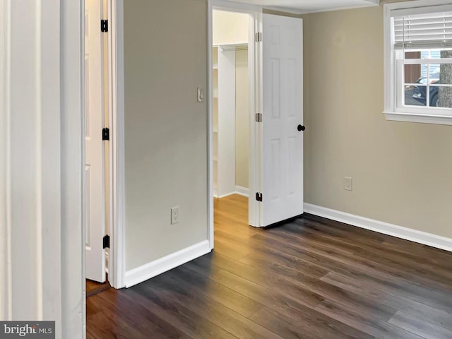 unfurnished bedroom featuring dark hardwood / wood-style floors and a closet