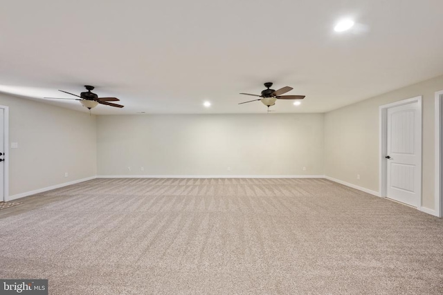 carpeted spare room with a ceiling fan, baseboards, and recessed lighting