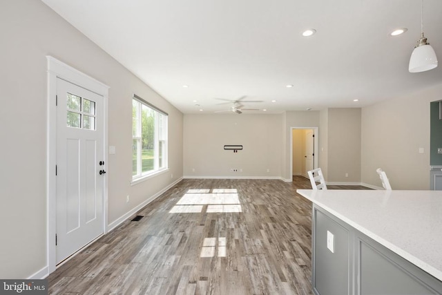 unfurnished living room with recessed lighting, a ceiling fan, baseboards, and light wood-type flooring
