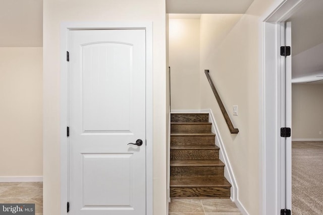 staircase featuring baseboards