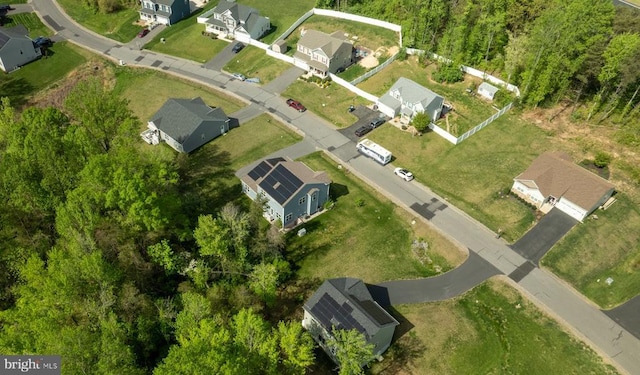 bird's eye view featuring a wooded view and a residential view