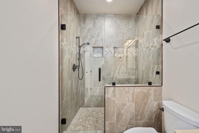 full bath with toilet and a stall shower