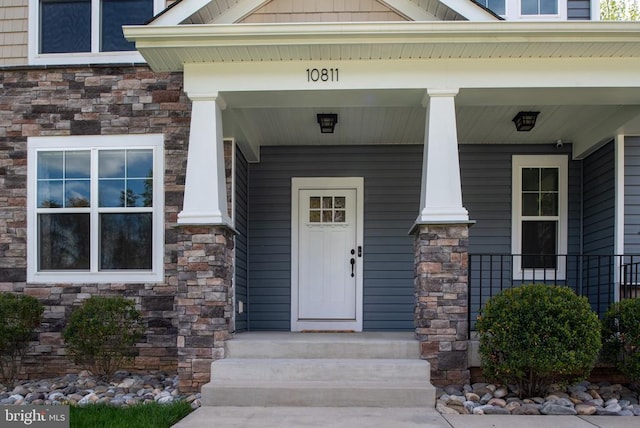 doorway to property featuring stone siding