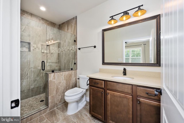 full bath featuring toilet, a shower stall, tile patterned flooring, and vanity