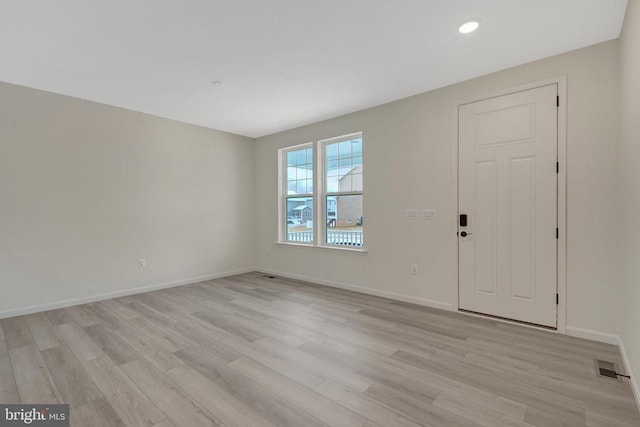 foyer featuring light wood-type flooring, visible vents, baseboards, and recessed lighting