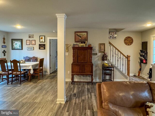 interior space featuring hardwood / wood-style flooring and decorative columns