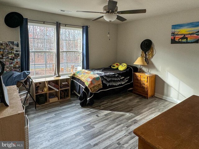 bedroom featuring light hardwood / wood-style flooring and ceiling fan