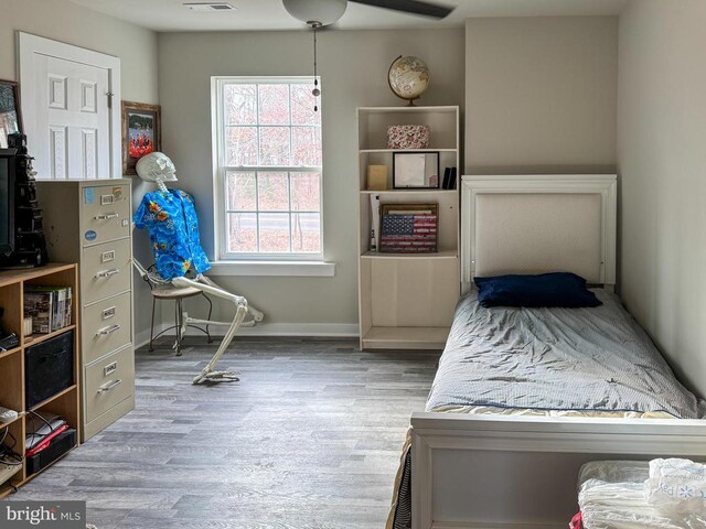 bedroom featuring hardwood / wood-style flooring and ceiling fan