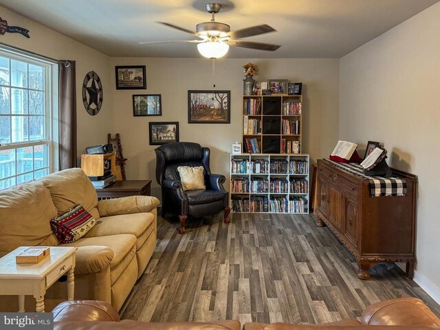 sitting room with dark hardwood / wood-style flooring and ceiling fan