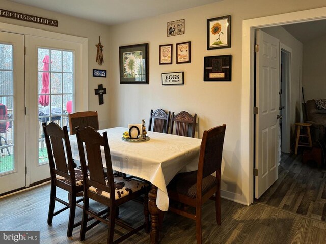 dining space with dark hardwood / wood-style flooring