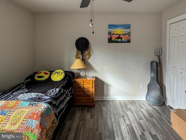 bedroom with ceiling fan and dark hardwood / wood-style flooring