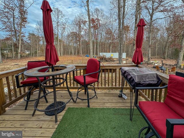 wooden terrace with an outdoor fire pit