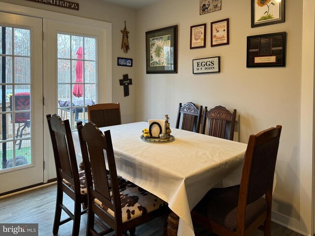 dining space with wood-type flooring