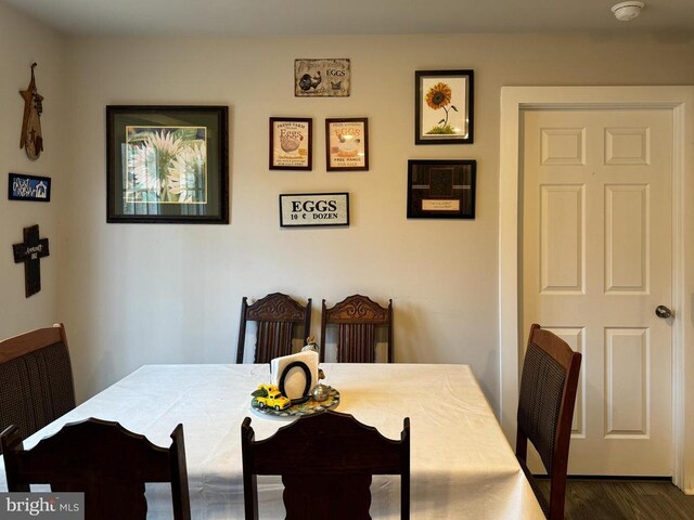 dining space with dark hardwood / wood-style floors