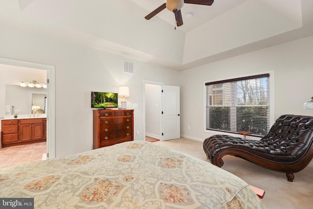 bedroom featuring high vaulted ceiling, connected bathroom, light carpet, visible vents, and baseboards