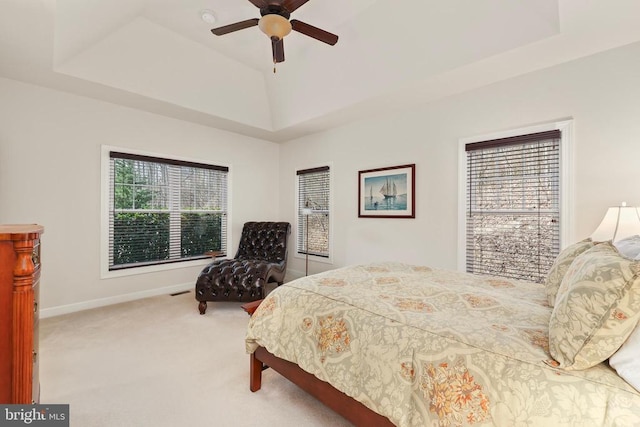 bedroom with baseboards, a raised ceiling, ceiling fan, vaulted ceiling, and carpet floors