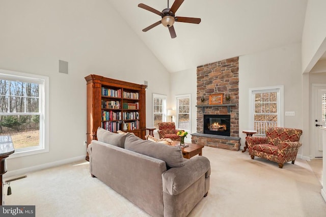 living room featuring light colored carpet, a fireplace, and visible vents