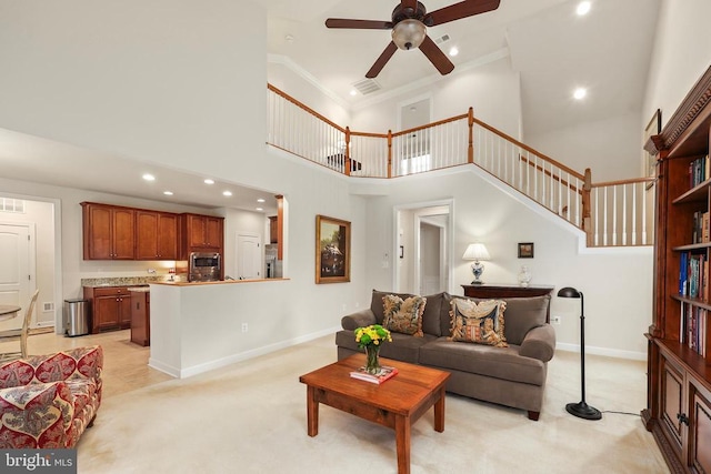 living room with recessed lighting, light colored carpet, visible vents, baseboards, and ornamental molding