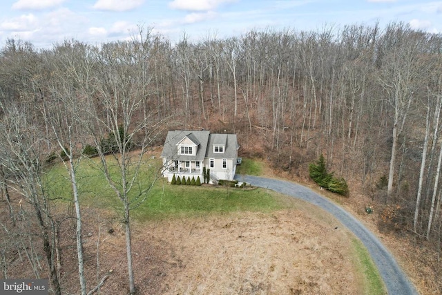 birds eye view of property featuring a wooded view