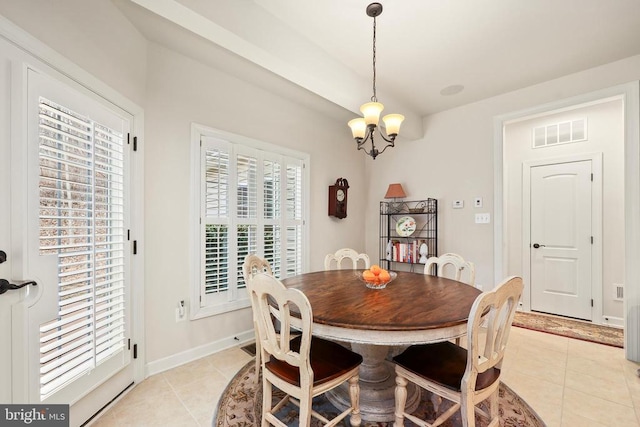 dining area with light tile patterned floors, baseboards, visible vents, and a chandelier