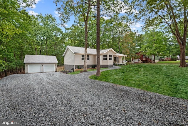 view of front of house with a garage, an outbuilding, and a front yard