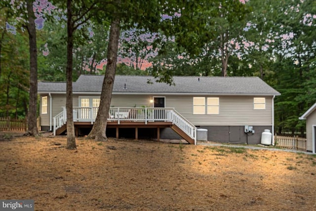 rear view of house featuring fence, stairway, a deck, and cooling unit