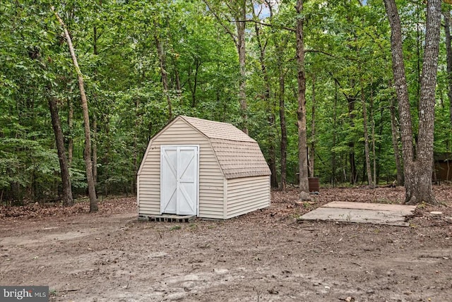 view of shed featuring a wooded view