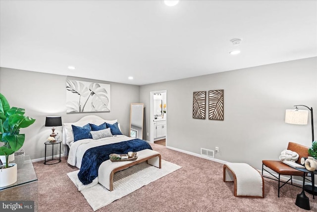 carpeted bedroom with recessed lighting, visible vents, baseboards, and ensuite bathroom