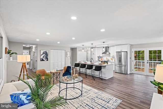 living room featuring dark wood-style floors, recessed lighting, and french doors