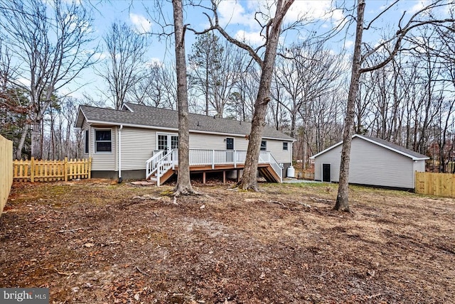 back of house featuring a shingled roof, stairway, fence, and a wooden deck