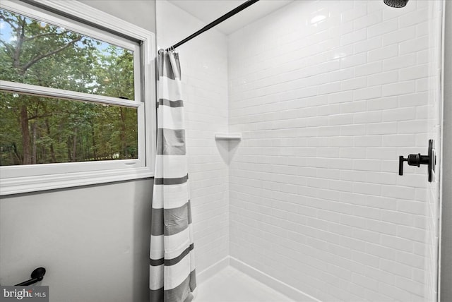 bathroom with tiled shower