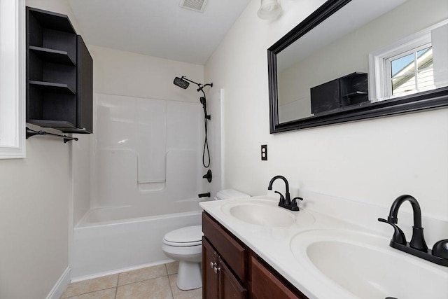 bathroom featuring washtub / shower combination, tile patterned flooring, a sink, and toilet